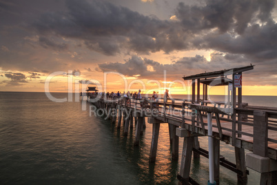 Pink and purple sunset over the Naples Pier on the Gulf Coast of