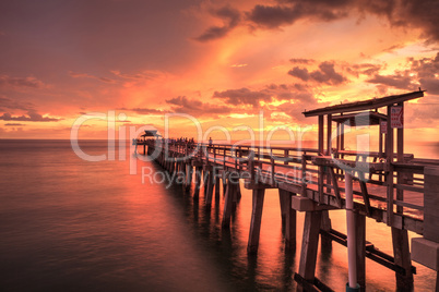 Pink and purple sunset over the Naples Pier on the Gulf Coast of