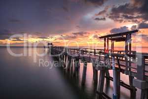 Pink and purple sunset over the Naples Pier on the Gulf Coast of