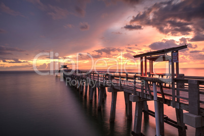 Pink and purple sunset over the Naples Pier on the Gulf Coast of