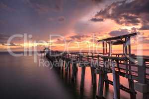 Pink and purple sunset over the Naples Pier on the Gulf Coast of