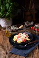 gnocchi baked with green pesto, cherry tomatoes and parmesan