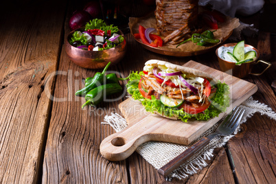 Crunchy pita with grilled gyros meat. Various vegetables and gar