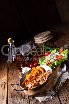 Rustic gyros plate it green salad and potato wedges