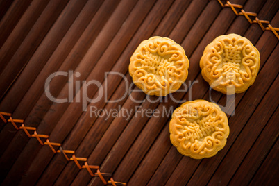 Mooncakes on bamboo mat low light with copyspace