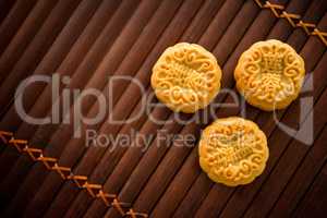 Mooncakes on bamboo mat low light with copyspace