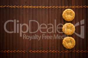 Mooncakes on bamboo mat low light with copy space