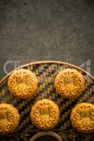 Moon cakes on bamboo background dark light with copyspace
