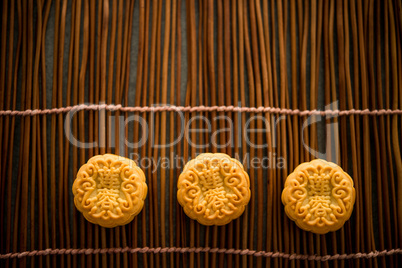 Mooncakes on bamboo mat with copy space dark light