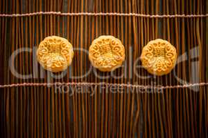 Moon cakes on bamboo mat with copy space low light