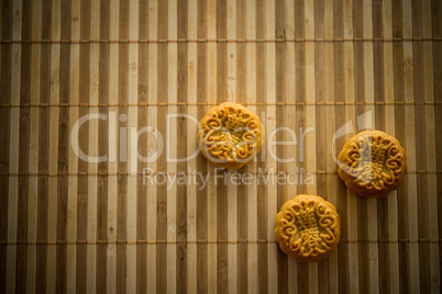 Mooncakes on bamboo mat with copy space low light