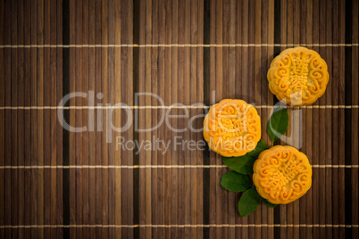 Top down moon cakes on bamboo mat with copy space