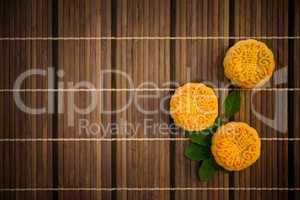 Top down moon cakes on bamboo mat with copy space