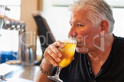 Handsome Man Tasting A Glass Of Micro Brew Beer