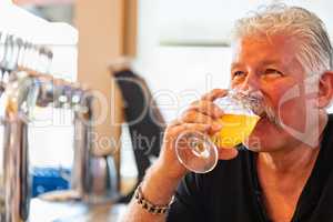 Handsome Man Tasting A Glass Of Micro Brew Beer