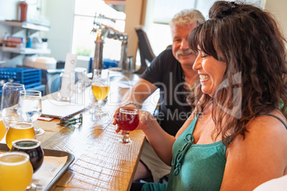 Group of Friends Enjoying Glasses of Micro Brew Beer At Bar