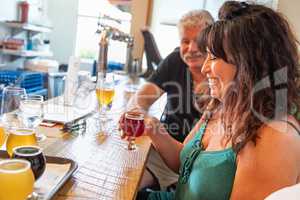 Group of Friends Enjoying Glasses of Micro Brew Beer At Bar