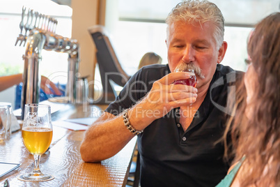 Handsome Man Tasting A Glass Of Micro Brew Beer