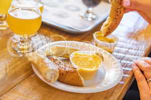 Woman Dipping Warm Pretzels in Cheese with Micro Brew Beer
