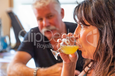 Couple Enjoying Glasses of Micro Brew Beer At Bar