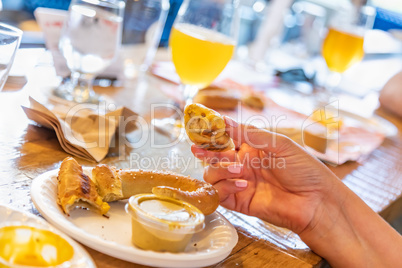 Woman Enjoys Warm Pretzels and Micro Brew Beer