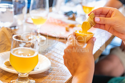 Woman Enjoys Warm Pretzels and Micro Brew Beer