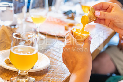 Woman Enjoys Warm Pretzels and Micro Brew Beer