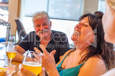 Group of Friends Enjoying Glasses of Micro Brew Beer At Bar
