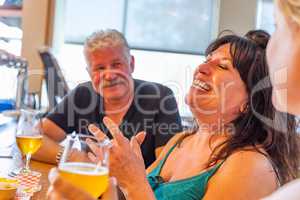 Group of Friends Enjoying Glasses of Micro Brew Beer At Bar