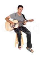 Young casual man playing the guitar