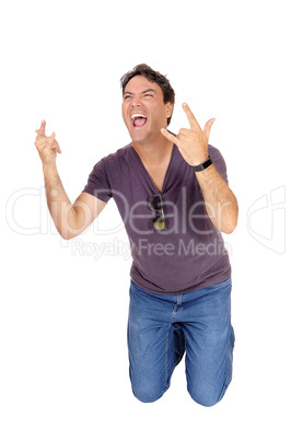 Screaming young man kneeling on floor