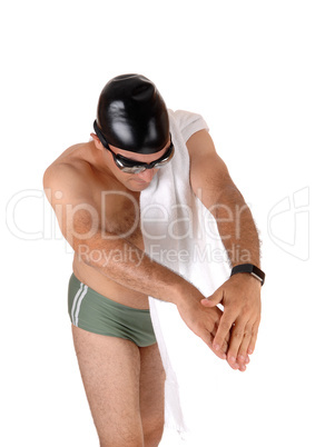 Young man in a swimsuit standing with hands forward