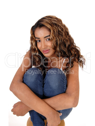 Beautiful happy young woman sitting on chair