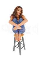 Beautiful happy smiling woman sitting on bar chair