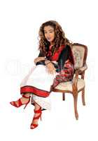 Beautiful East Indian woman sitting in armchair