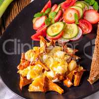 fresh chanterelles with scrambled eggs and a green salad