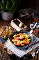 gnocchi baked with green pesto, cherry tomatoes and parmesan