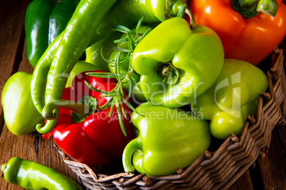 various harvested peppers and hot peppers in basket