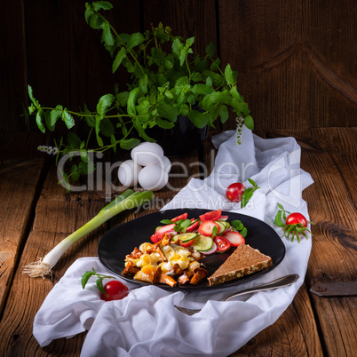 fresh chanterelles with scrambled eggs and a green salad