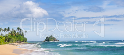 Picturesque beach and blue sky. Coastline of Sri Lanka. Wide pho