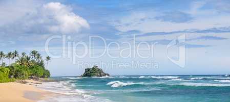 Picturesque beach and blue sky. Coastline of Sri Lanka. Wide pho