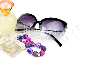 Perfume bottles, sunglasses and bracelet isolated on white backg