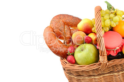 A set of fruits and pastries in a woven basket isolated on white