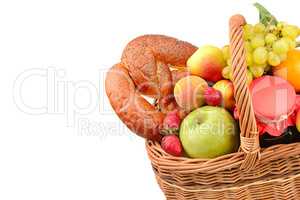 A set of fruits and pastries in a woven basket isolated on white