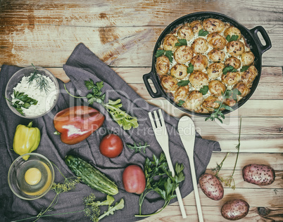 Young potatoes with cottage cheese are baked in the oven.