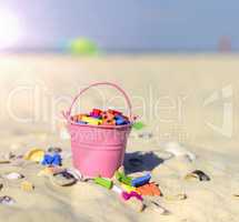pink baby iron bucket filled with wooden colorful letters