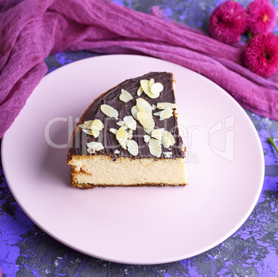 pieces of cheesecake with chocolate on a pink plate, close up