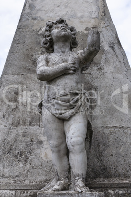 stone statue of a child on a pedestal