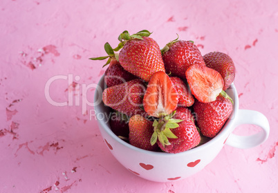 fresh red strawberry in a white ceramic mug