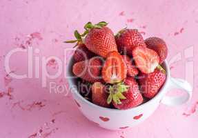 fresh red strawberry in a white ceramic mug